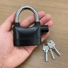 Black alarmed security padlock shown in an adult hand with three supplied keys