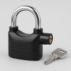 Close-up of the black padlock body, steel shackle, side key cylinder and matching key