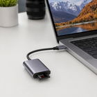 Grey memory card reader connected to a USB-C laptop with an SD card inserted