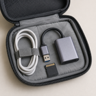 Compact grey memory card reader stored in a travel tech pouch