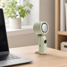 Rechargeable fan standing beside a laptop on a home-office desk