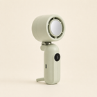 Sage green five-speed rechargeable handheld fan standing upright