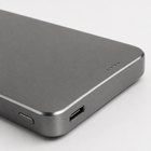 Close-up of the grey power bank USB-C port, power button and battery indicators