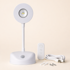 White rechargeable wall light with remote, USB cable and mounting fittings