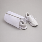 White zip shoe washing bag shown with adult trainers